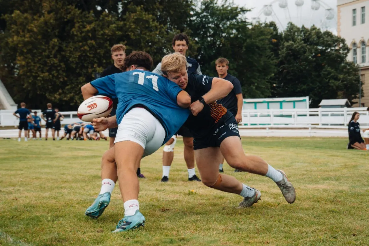 Rugby players practising a tackle during a training session