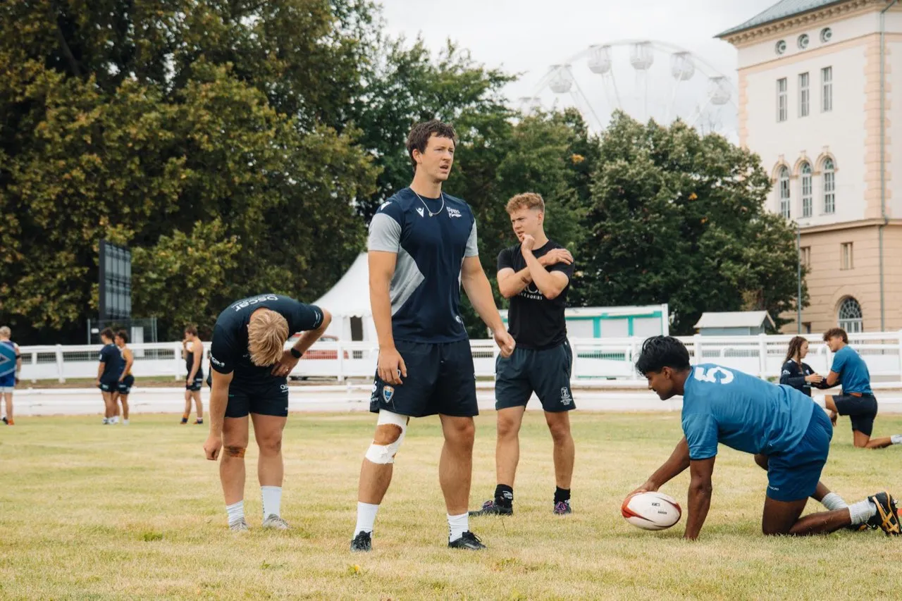 A rugby team training together on the pitch