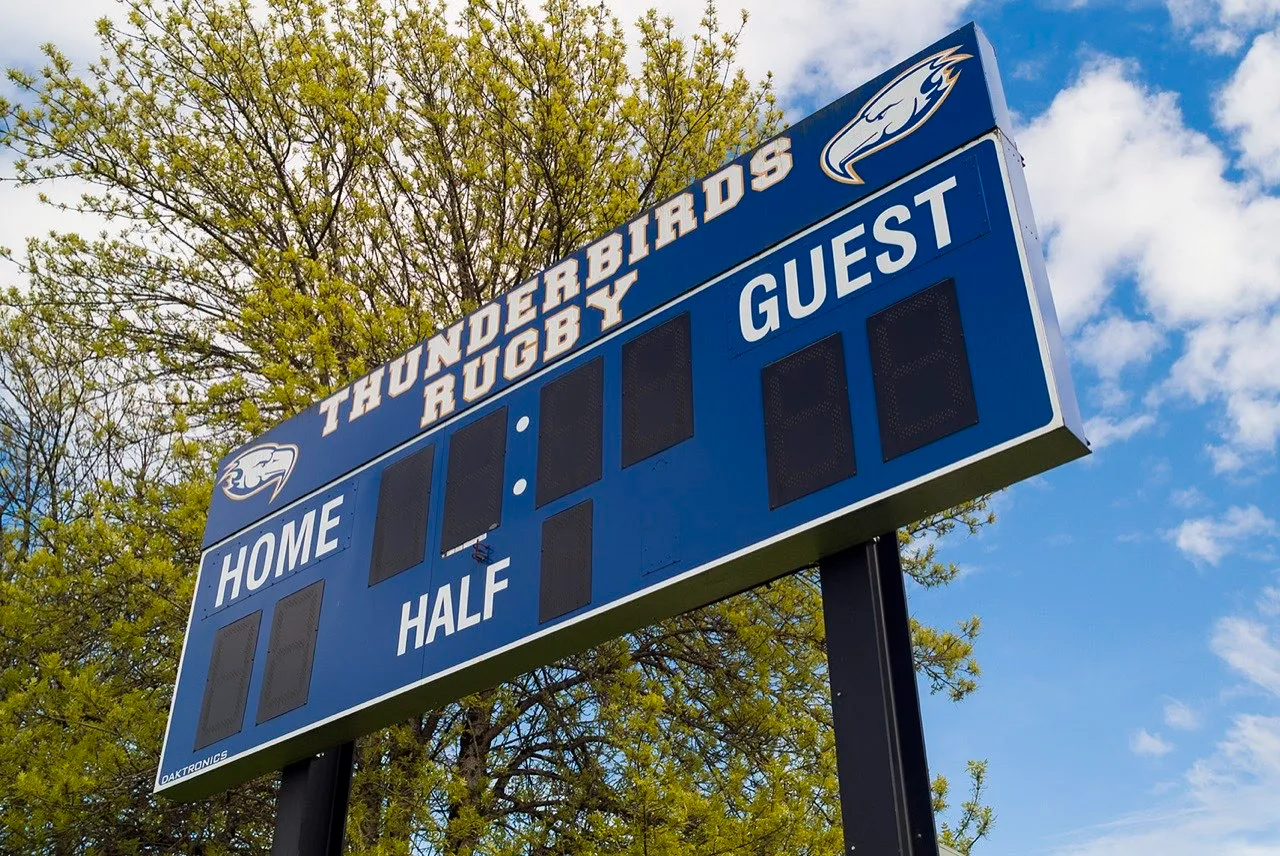 A blue rugby scoreboard reading Thunderbirds Rugby, with home, guest and half panels
