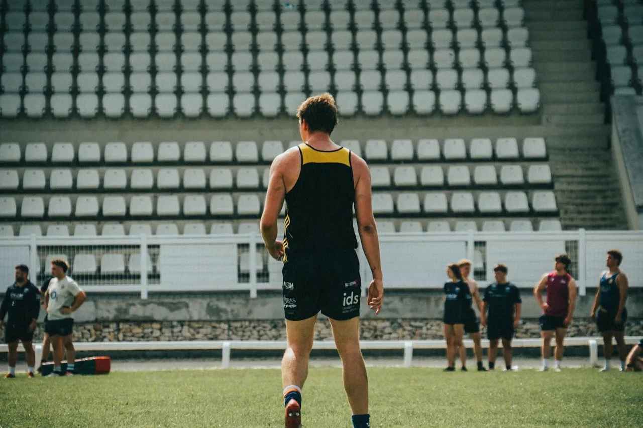 A rugby player in training kit during a session in front of empty stands