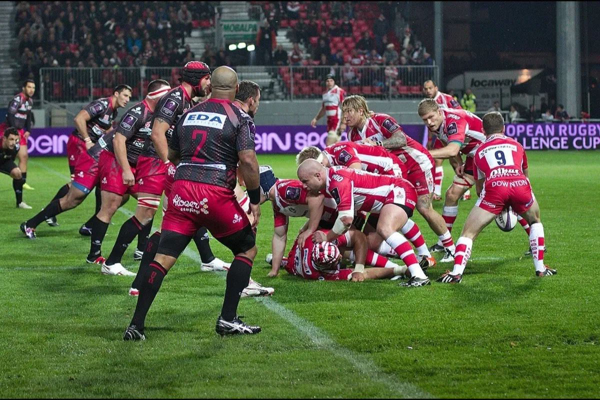 Two rugby packs drive over the ball at a ruck