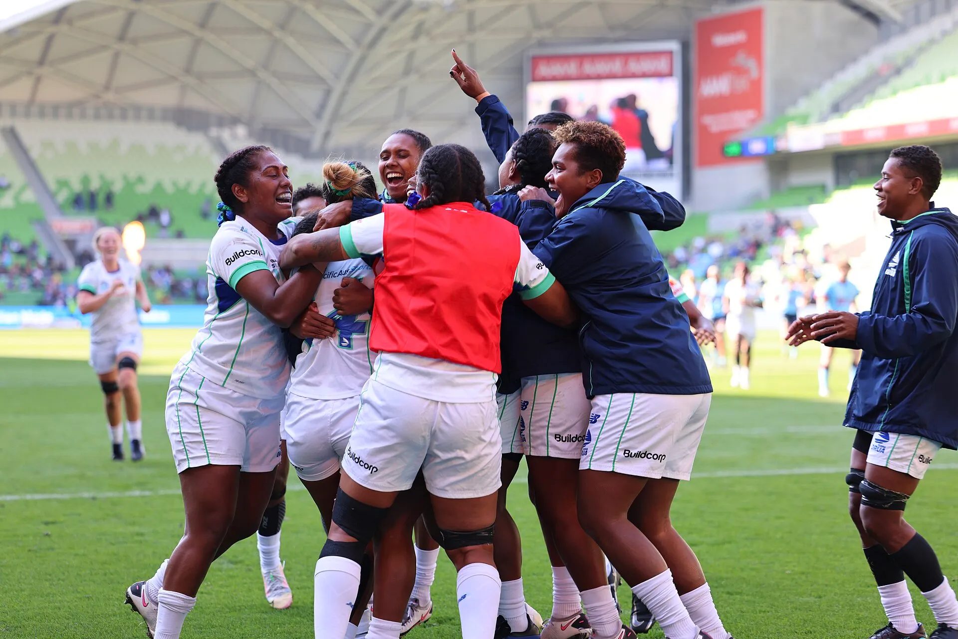 Players celebrating together after a womens rugby final