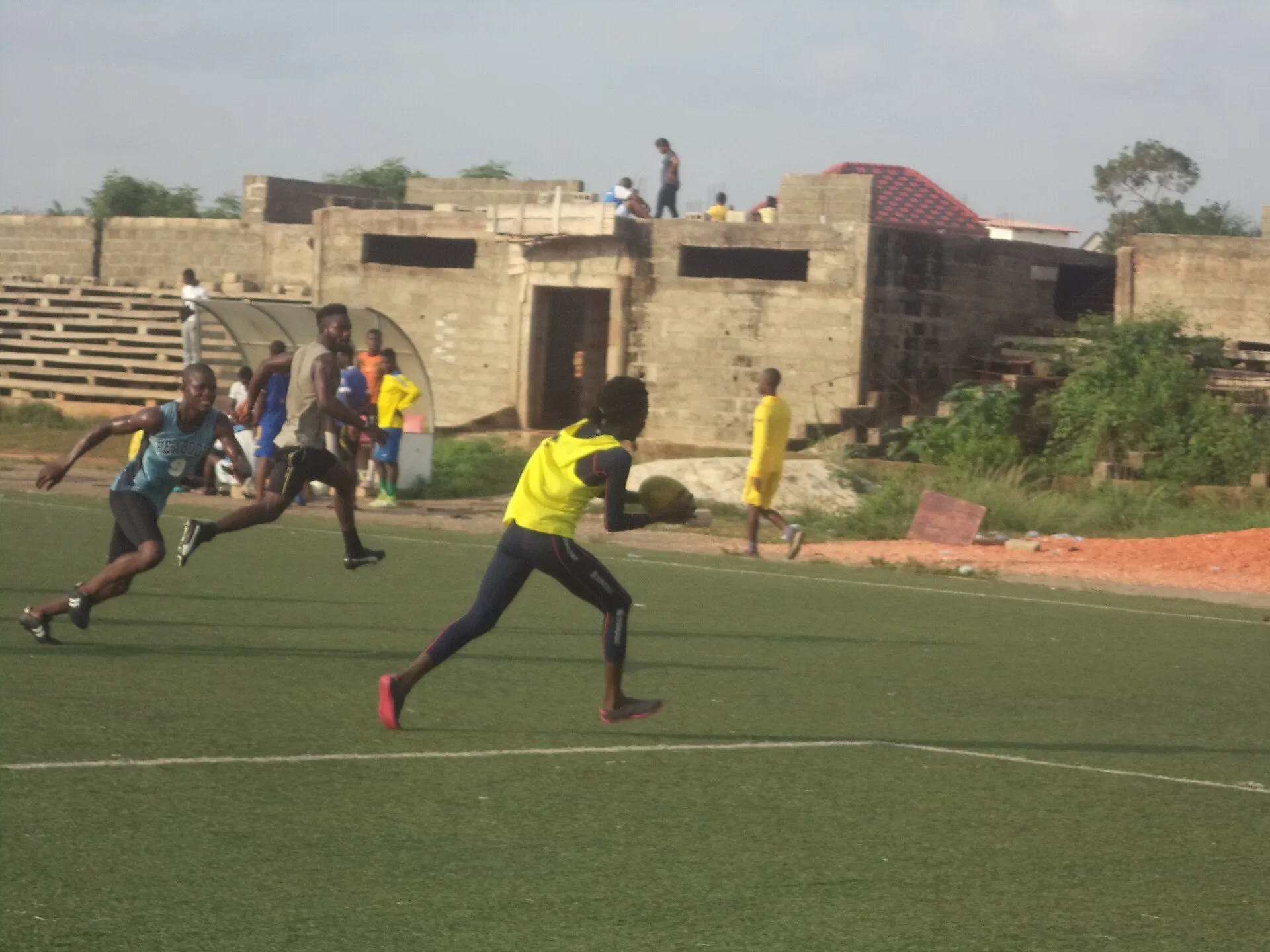 A player runs with the ball during a rugby training session
