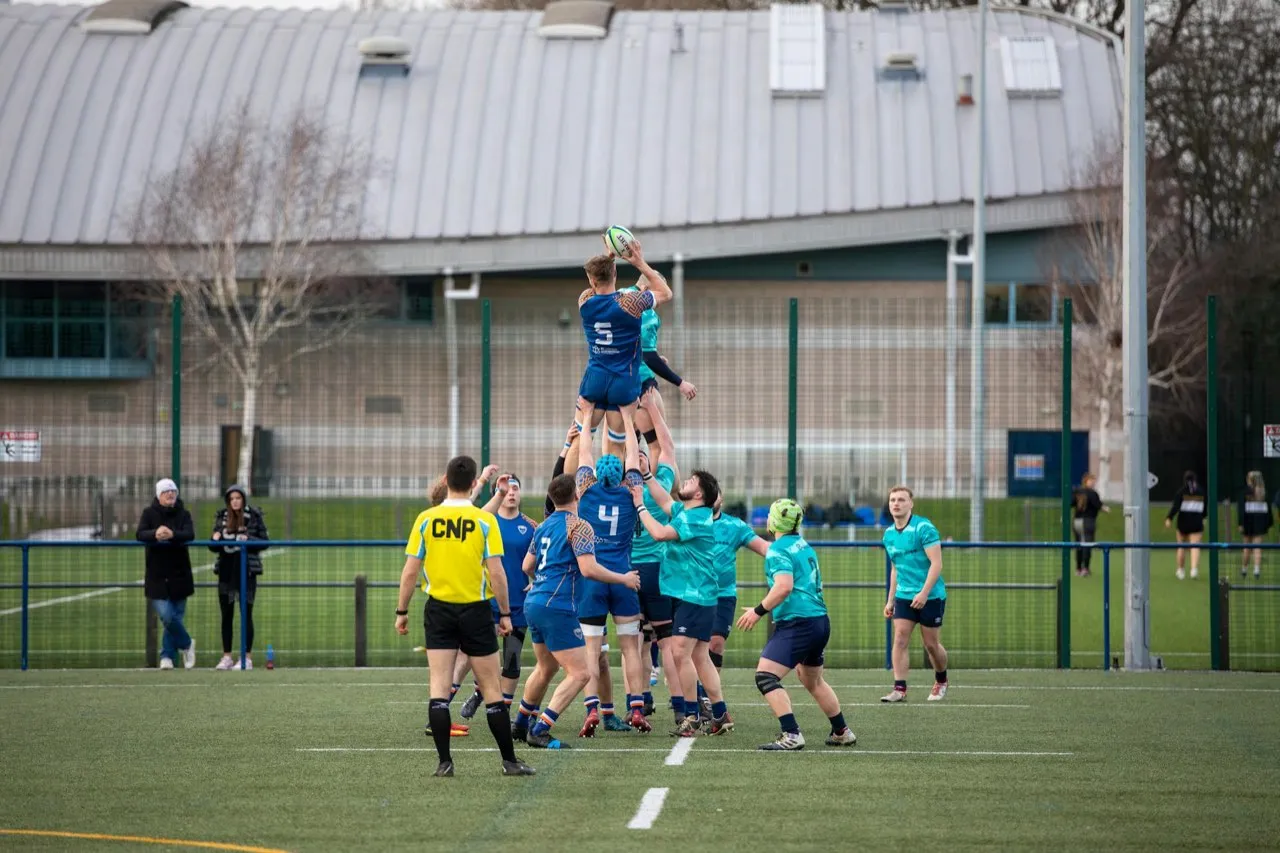 Rugby players lifting a jumper to win lineout ball during a match