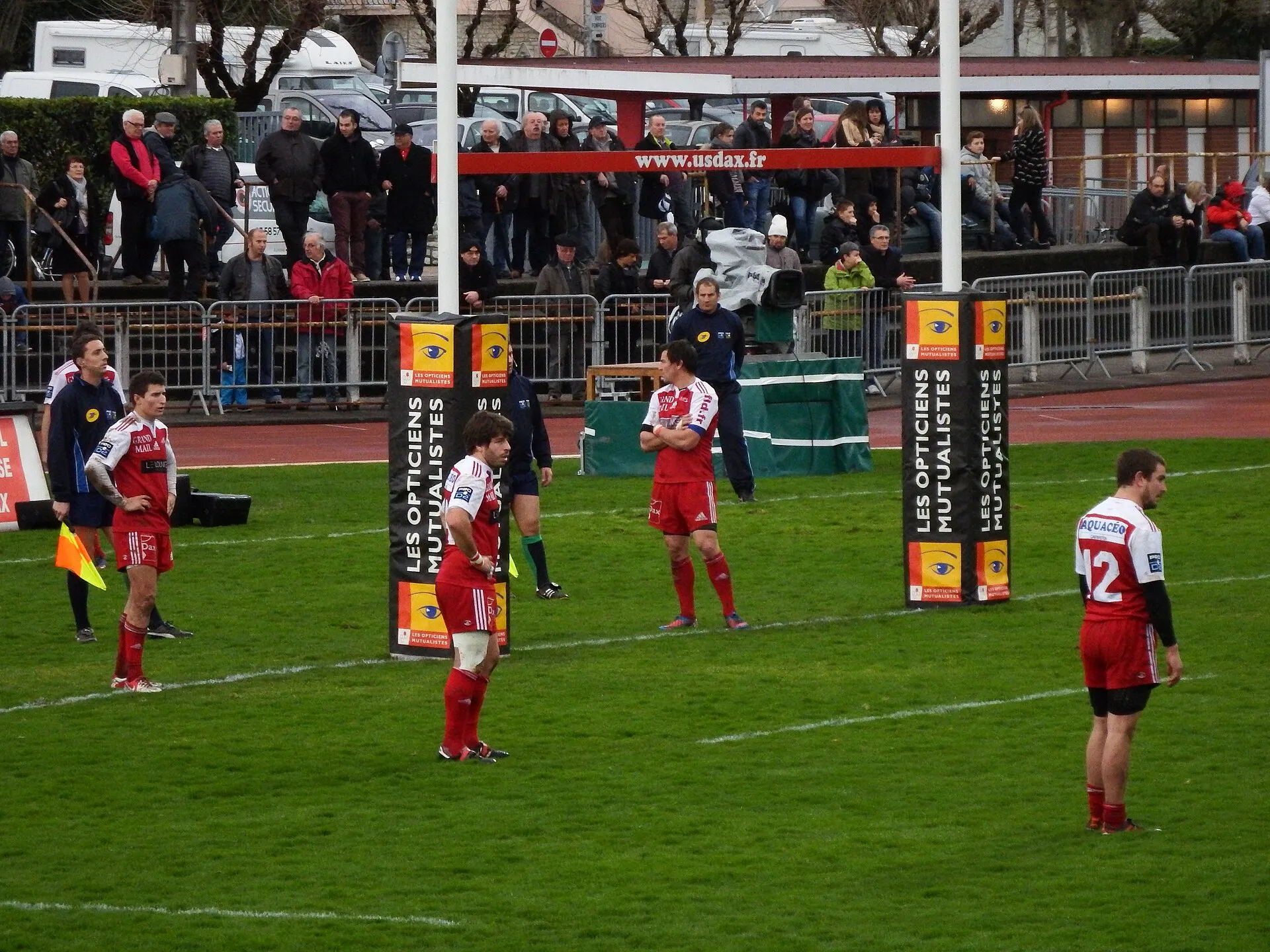 A television camera films a rugby match from behind the in-goal area