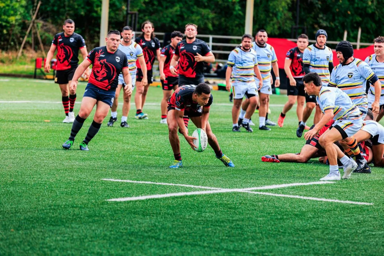 A rugby player breaking through the defensive line with the ball during a match