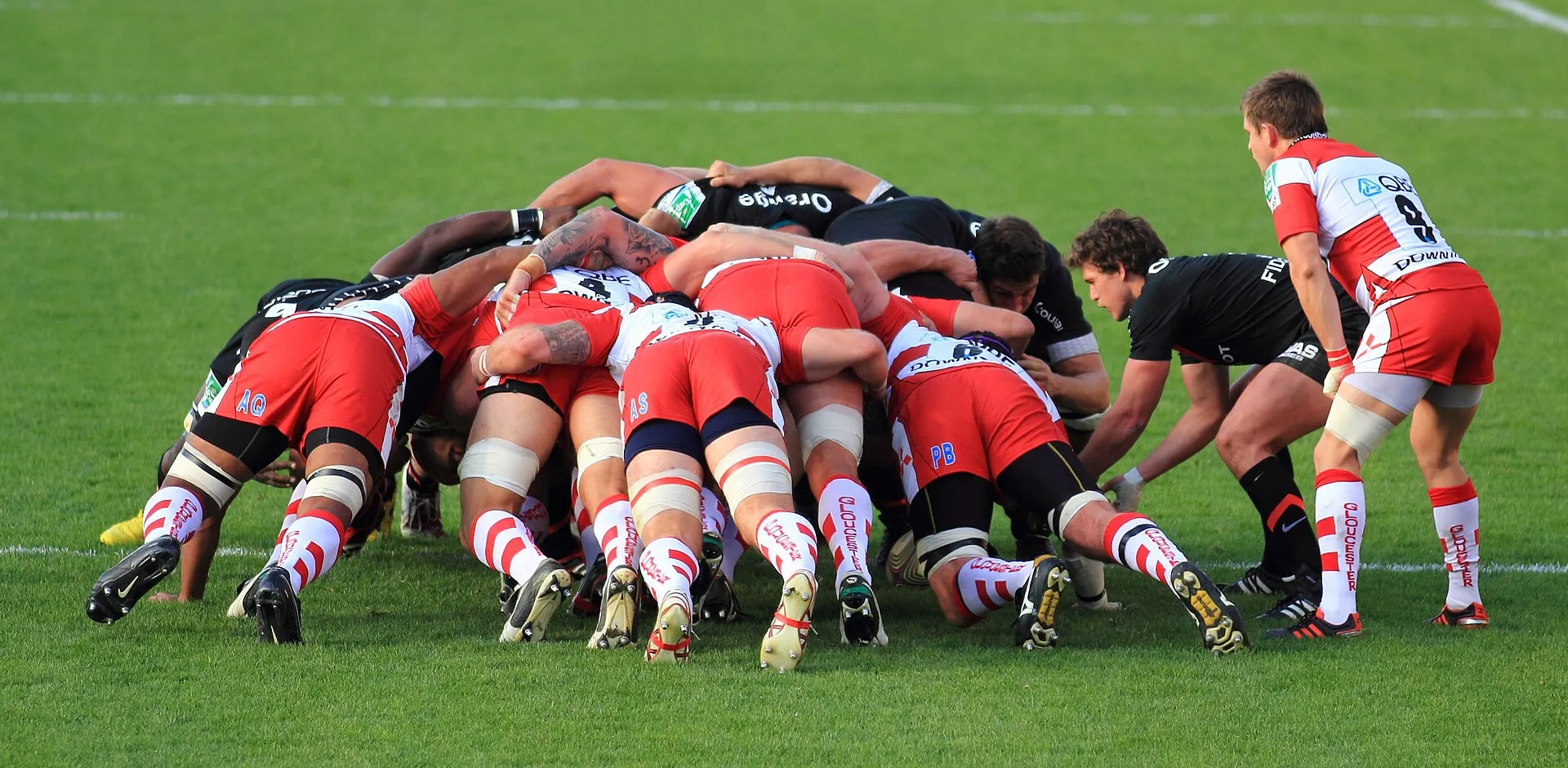 Two packs of forwards engage in a scrum during a rugby match