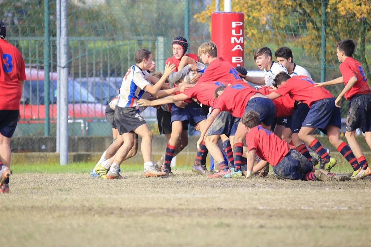 A team keeps the ball in a maul during a rugby match